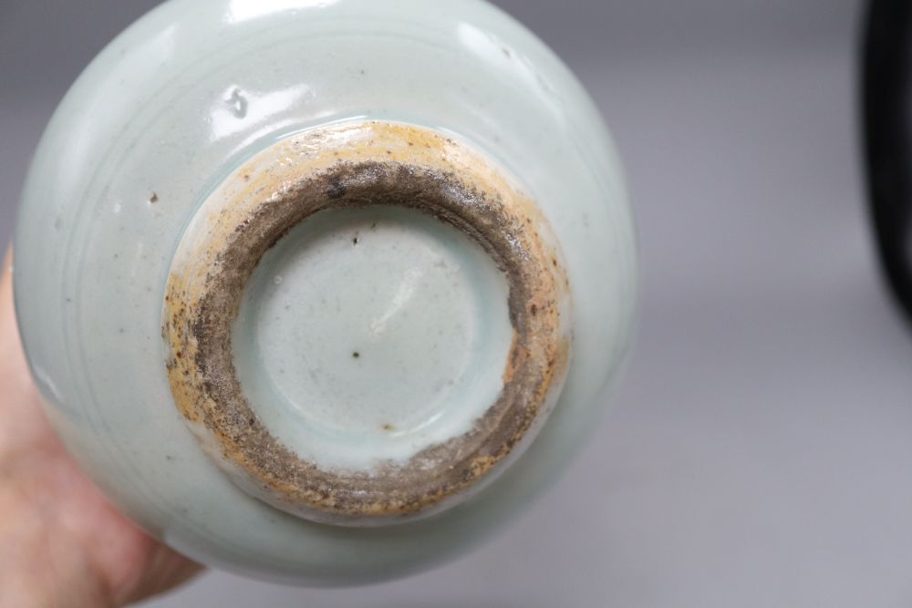 A 17th century Chinese celadon glazed vase, height 26.5cm (a.f) and a pin dish